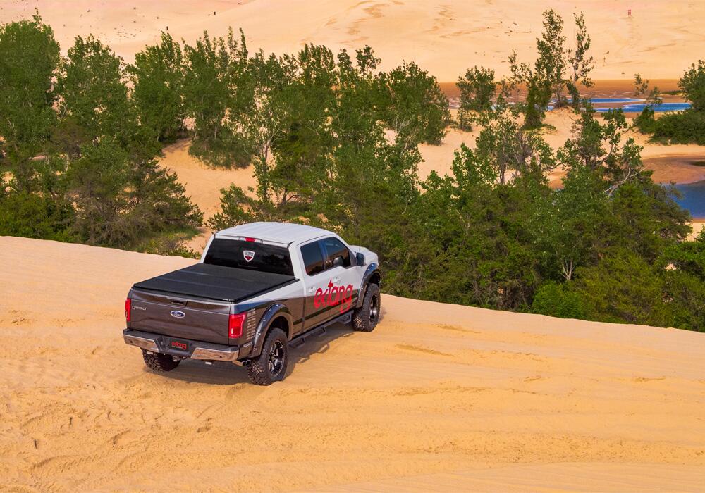 Solid Fold 2.0 Tonneau Cover Black Textured Paint 2019 (New Body Style)-2025 Chevy/GMC Silverado/Sierra 1500 8' 2 inch Bed without Factory Side Storage Boxes without CarbonPro Bed with or without MultiPro/MultiFlex Tailgate Extang